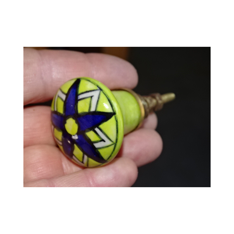 pastel green pear-shaped button and ultramarine flower