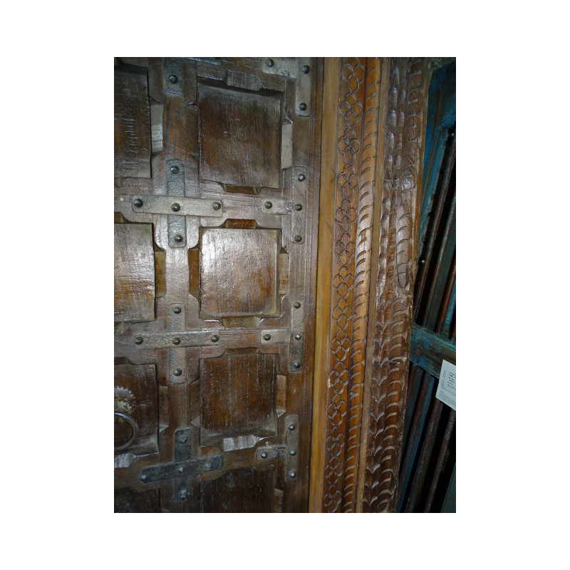 Patinated house door in dark with steel fittings