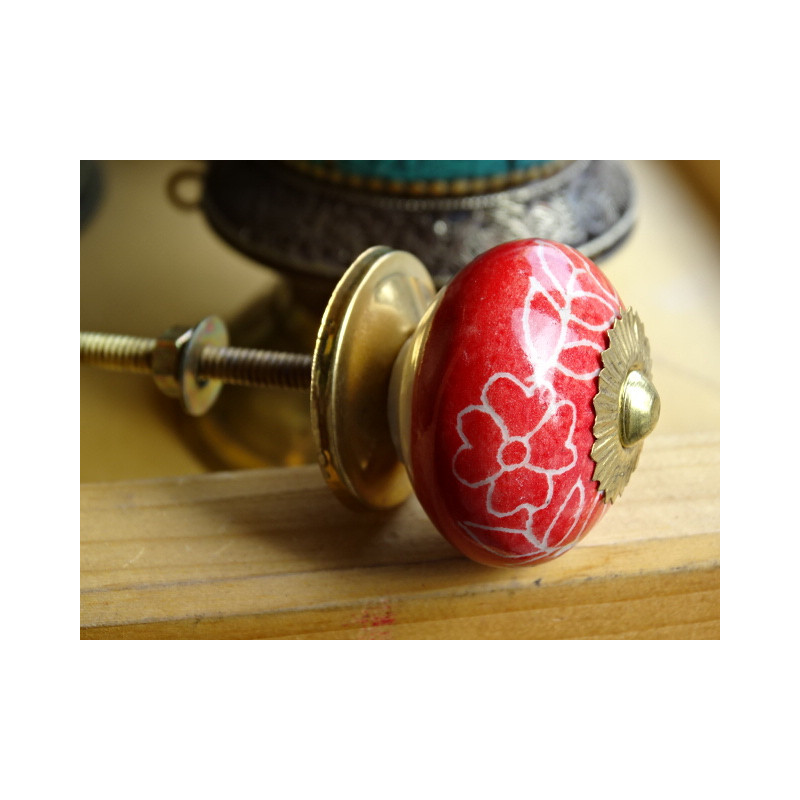 Red porcelain drawer handle and white flowers