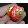 Red porcelain drawer handle and white flowers