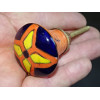 orange pear shaped button and yellow and ultramarine flower